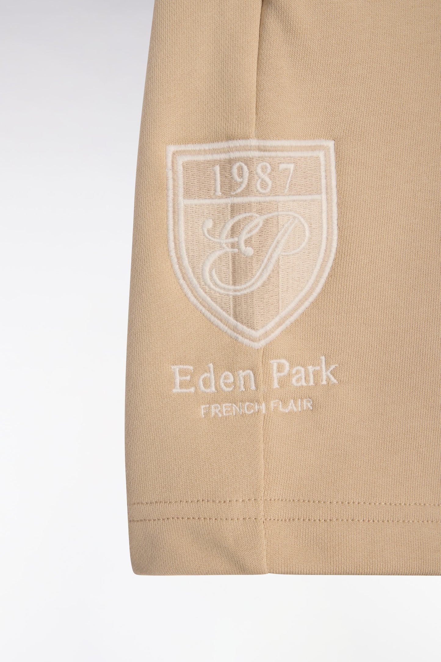 Beige cotton fleece shorts with coat of arms embroidery