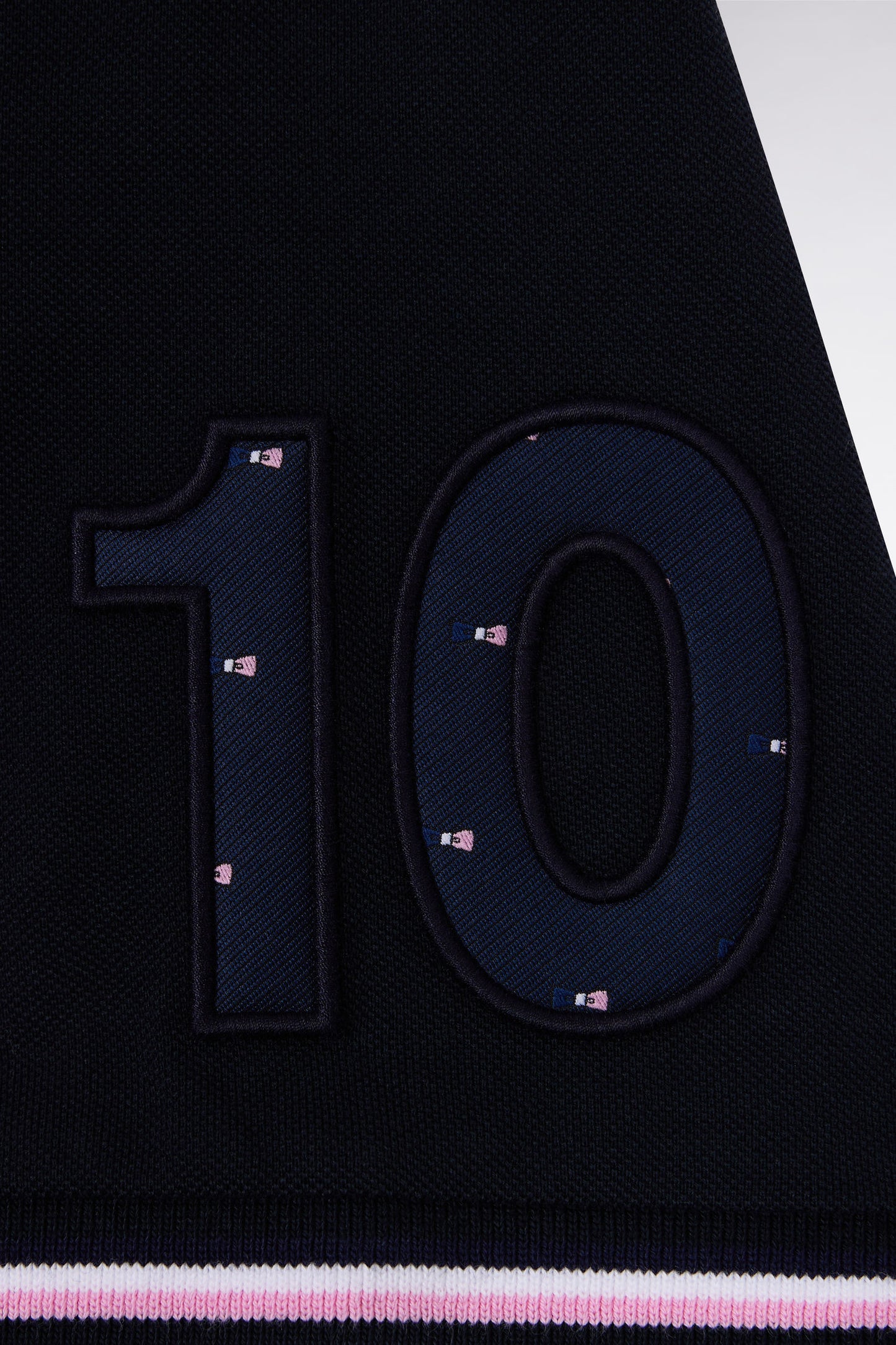 Short-sleeved pink and navy polo shirt with tricolored trim, straight cut