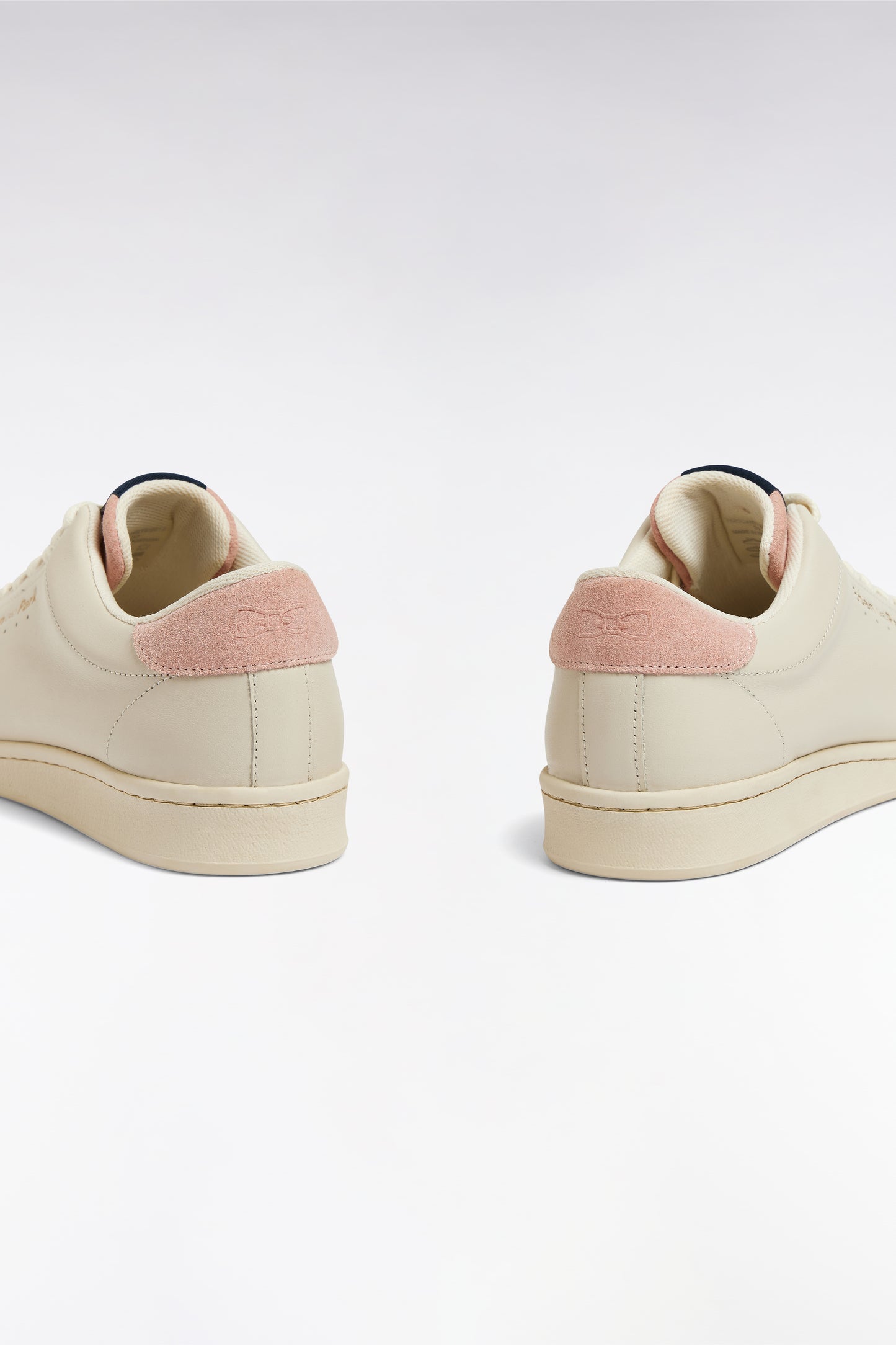 White leather low-top sneakers with pink accents