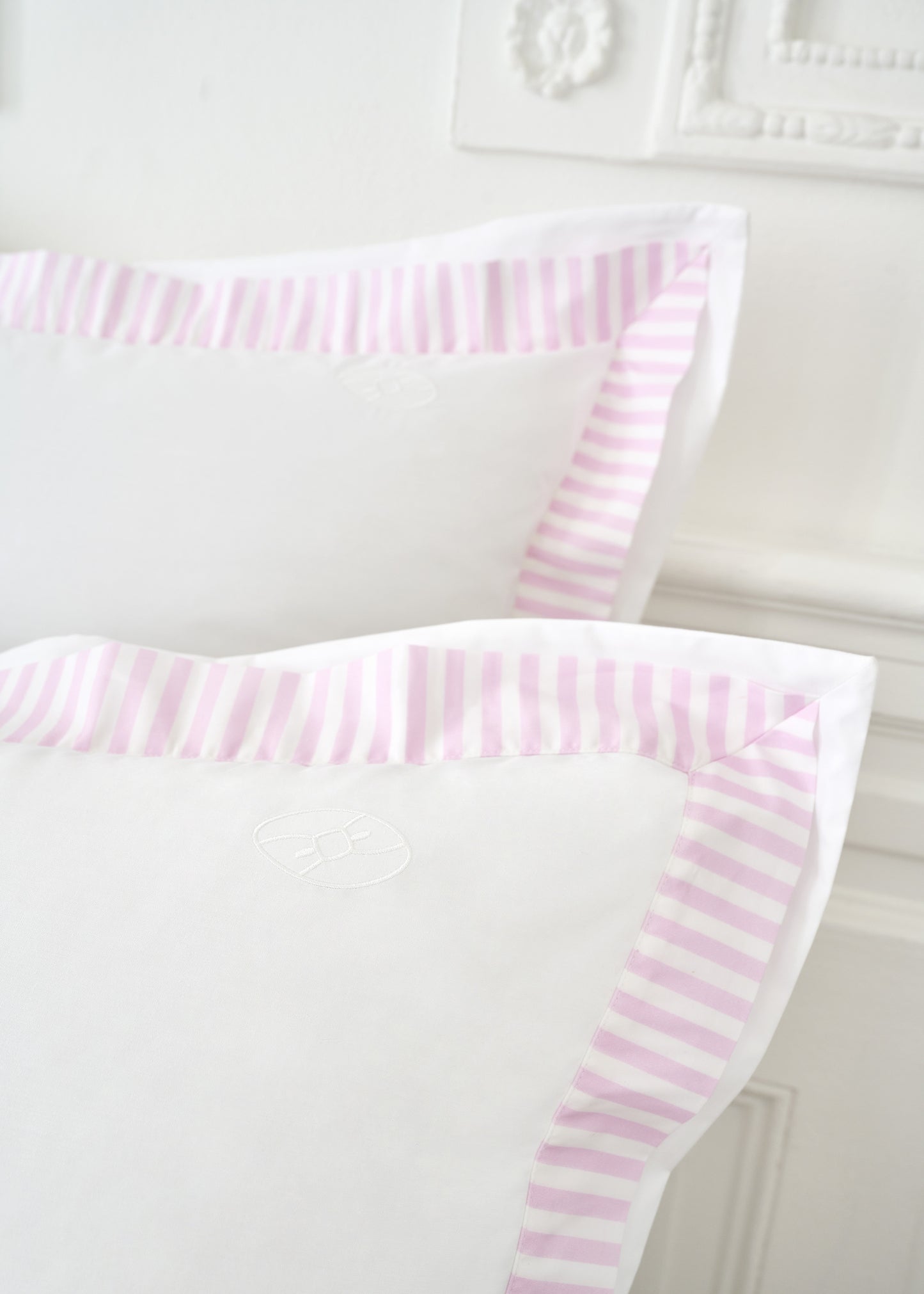 Set of square white cotton pillowcases with pink striped trim