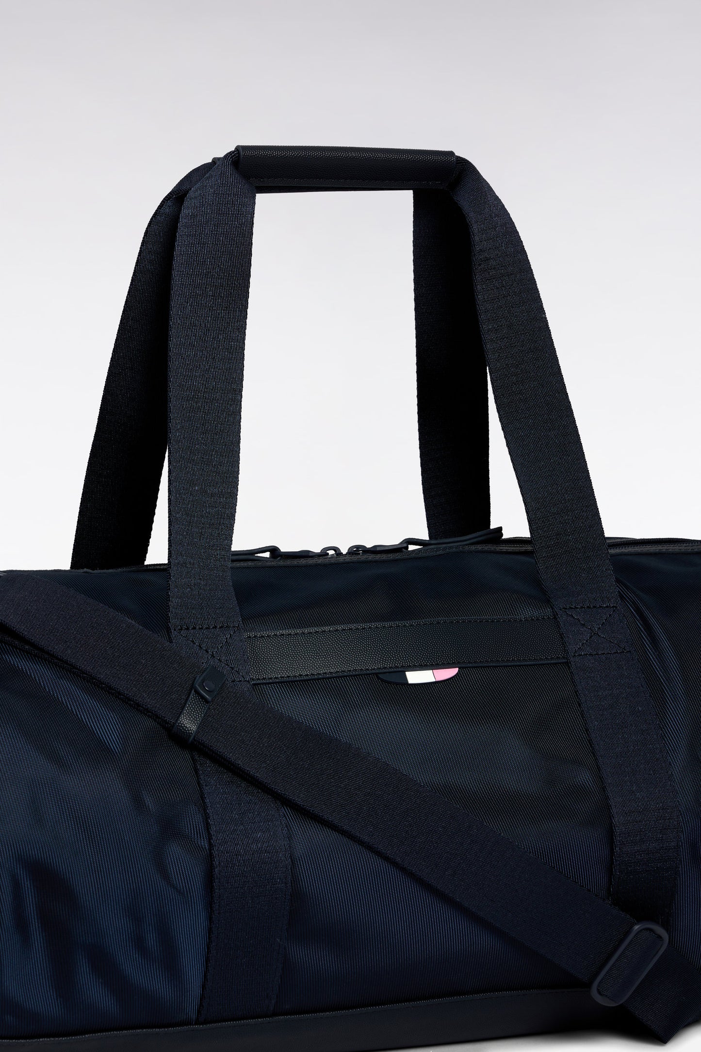 Navy and black duffle bag in leather and fabric