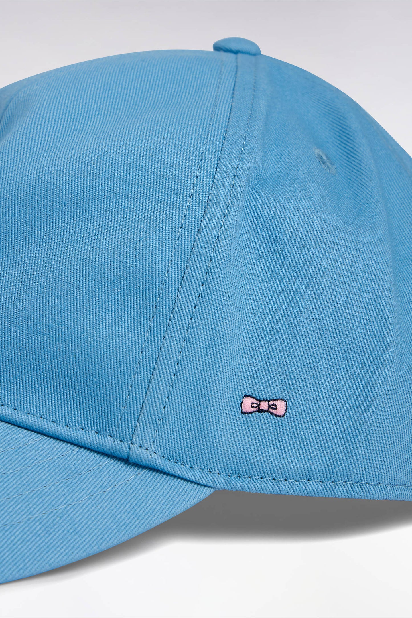Sky blue cotton twill cap with bow tie embroidery