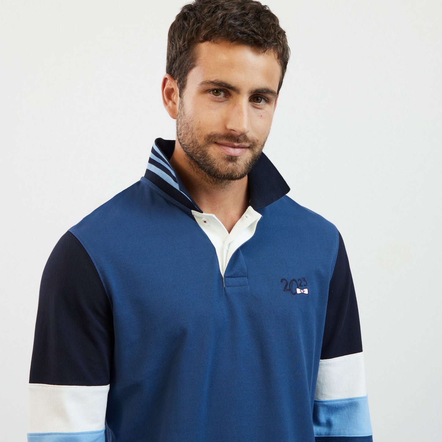 Blue colourblock polo shirt with 2023 embroidery