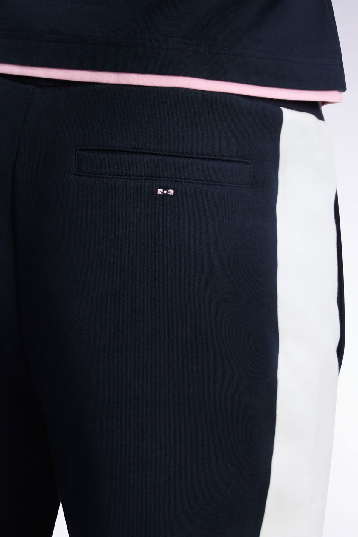 Navy fleece joggers with contrasting leg cutouts, straight cut